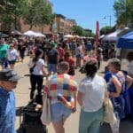 Crowded street of booths and people for a farm market in downtown Appleton, WI
