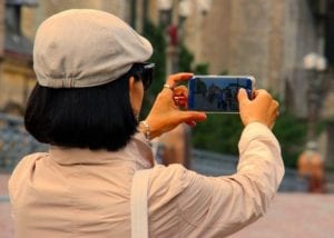 Lady taking picture with cell phone