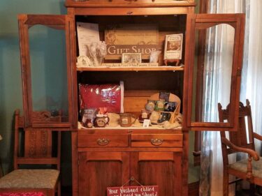 open cabinet in Gift Shop displaying items for sale