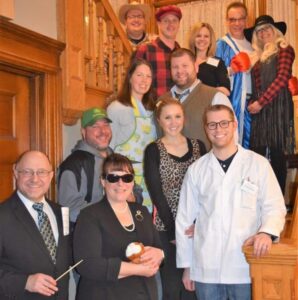 Costumed Murder Mystery guests pose for group photo on Franklin Street Inn Grand Staircase