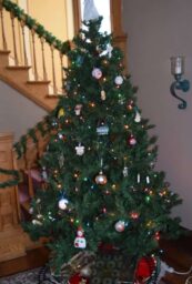 Christmas tree in entryway decorated with ornaments