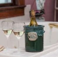 bottle and glasses of wine perched on side of tub