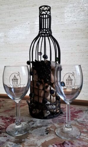 2 wine glasses and wire holder for corks in the shape of a wine bottle